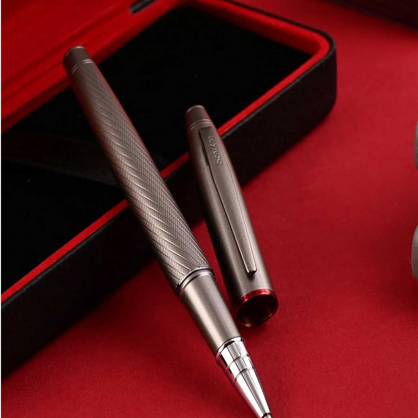 Scrikss Noble 35 Rollerball Pen in Matte Titanium on a red and black box